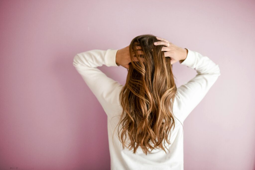 Woman with long healthy hair, from a New Zealand guide to biotin for hair, skin and nails