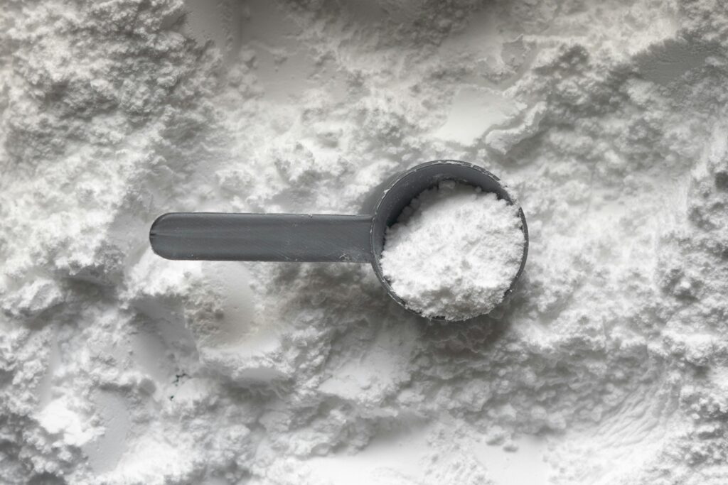 Scoop of protein powder, from a New Zealand guide to whey, plant and collagen protein options